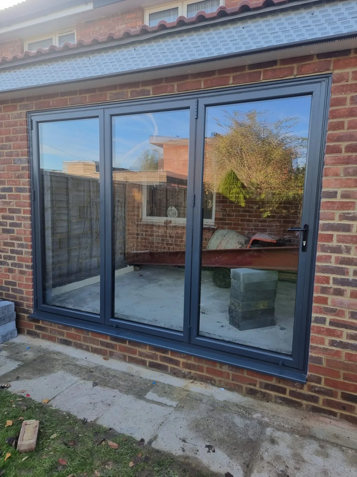 Grey bi-folds on red brick