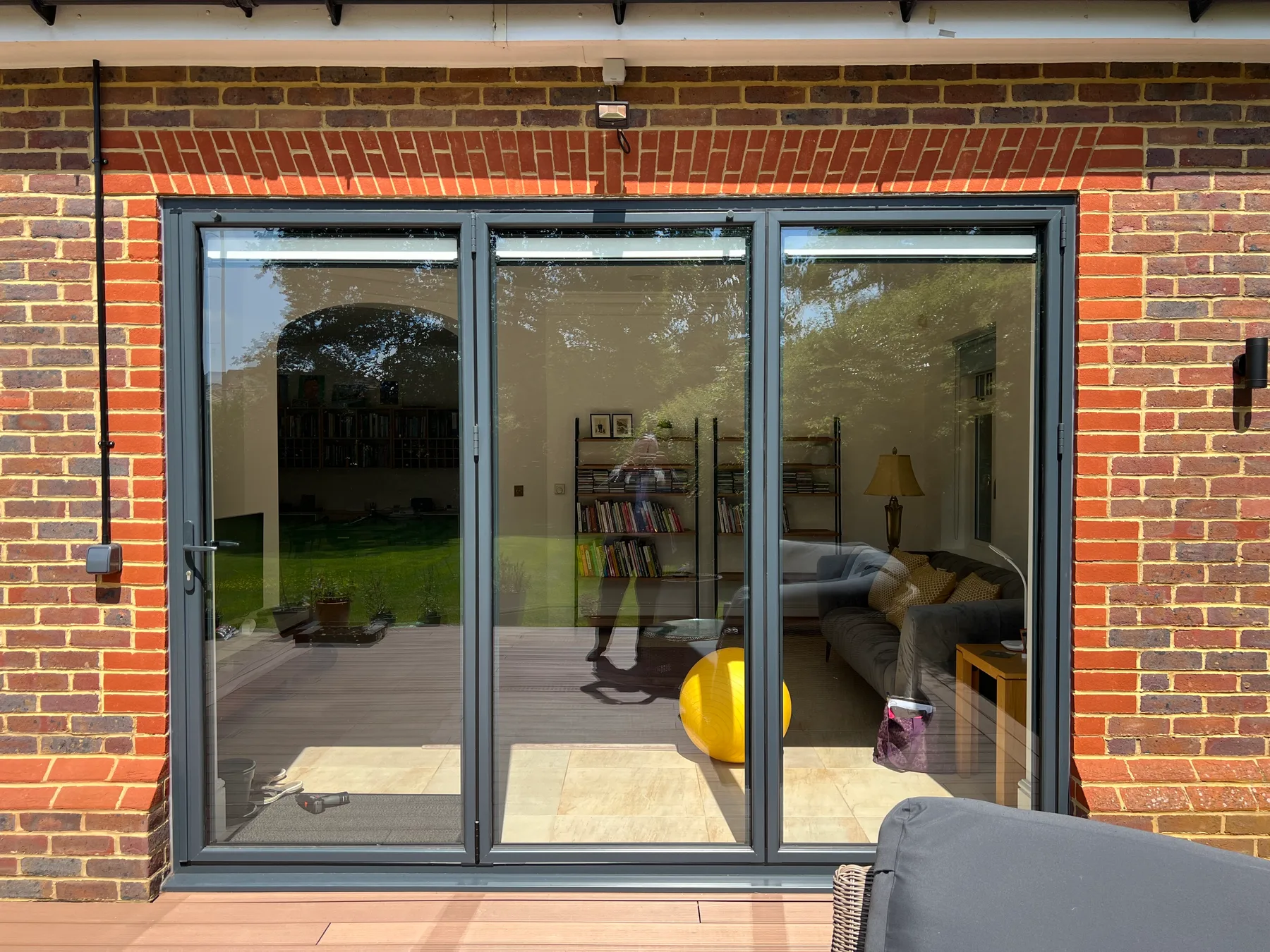 Grey bi-folds onto a brick patio
