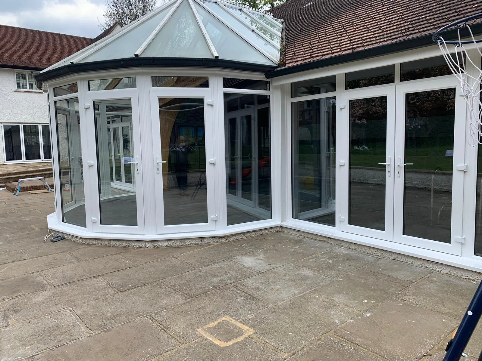 Conservatory and glazed link onto a paved walkway