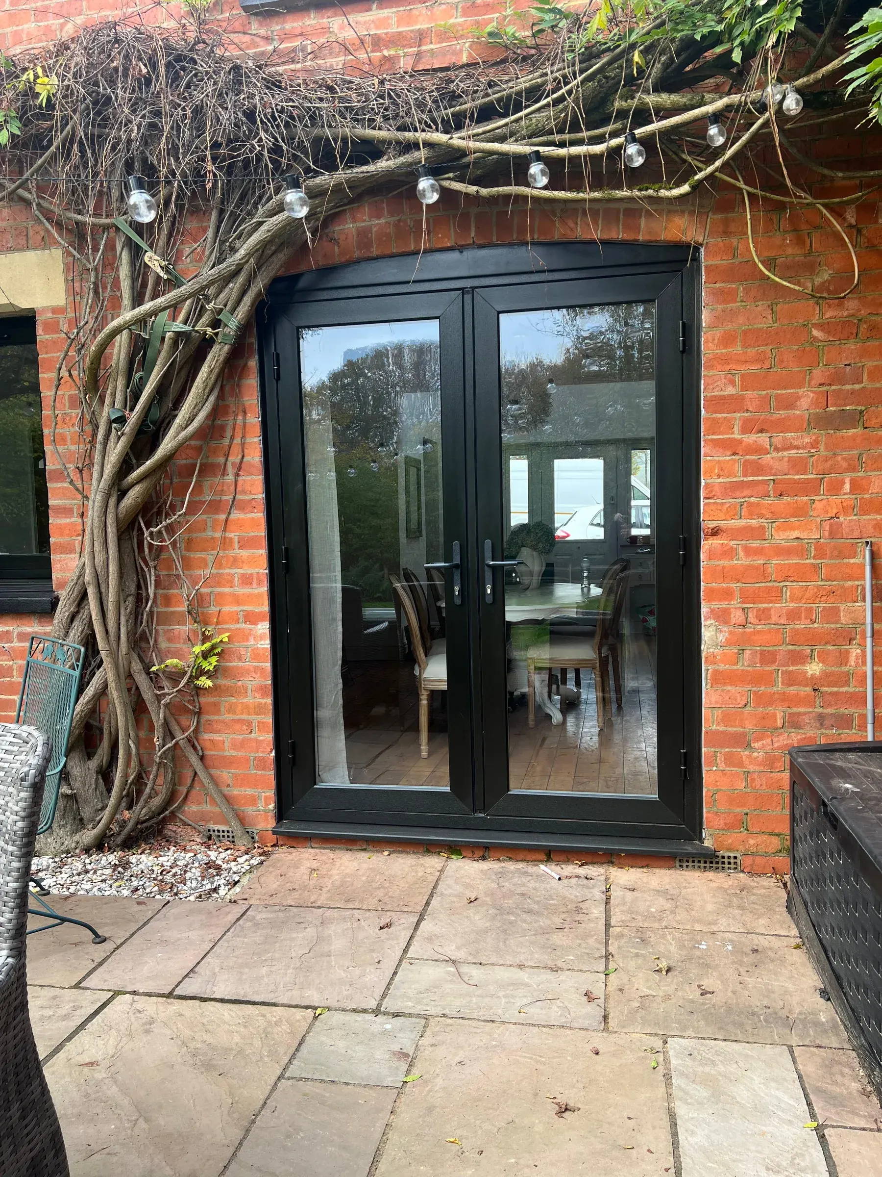 Anthracite French doors · brick patio