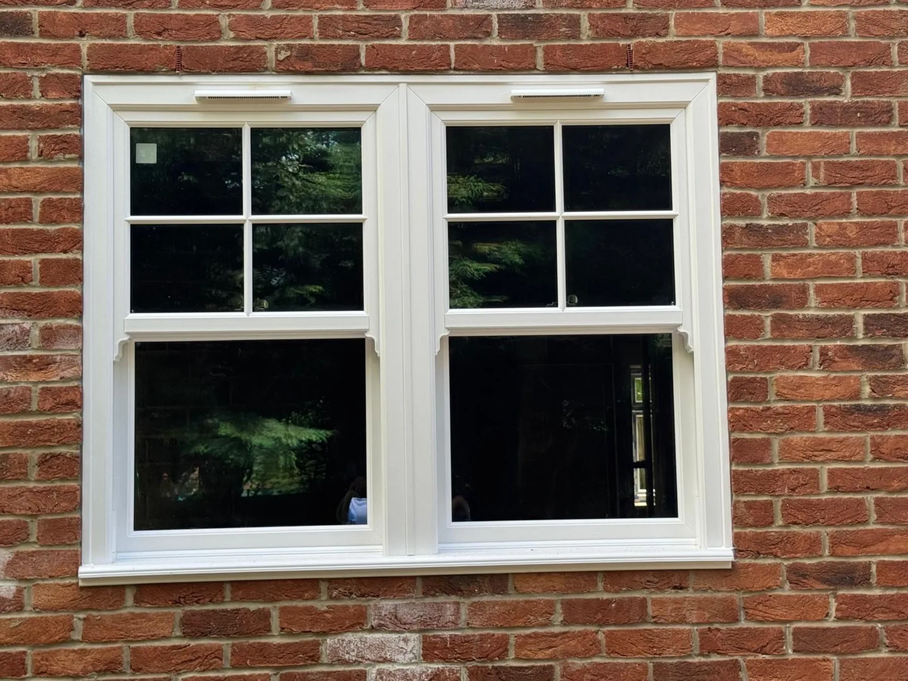 White sash windows on red brick